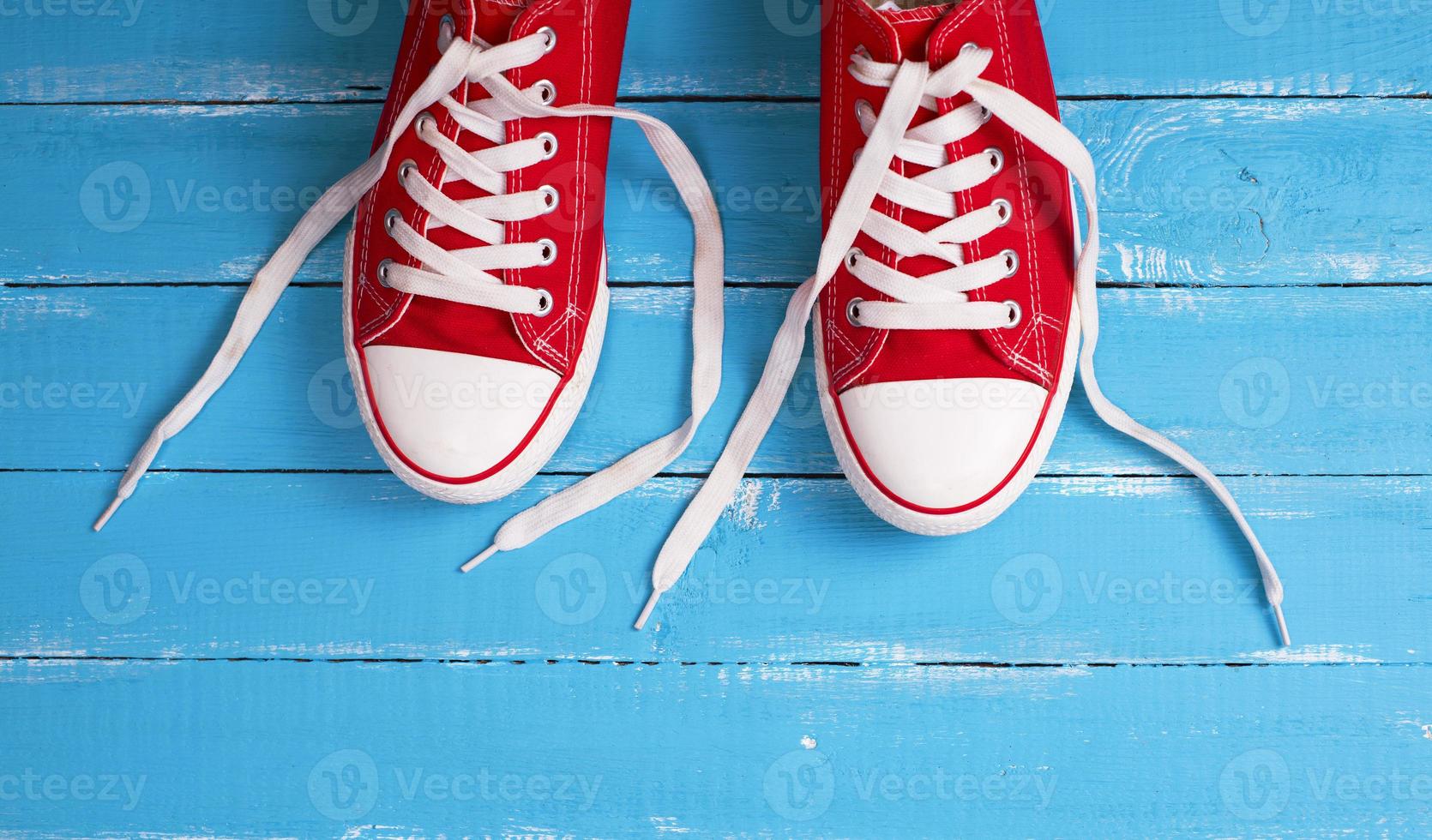 pair of red  sneakers with white laces photo