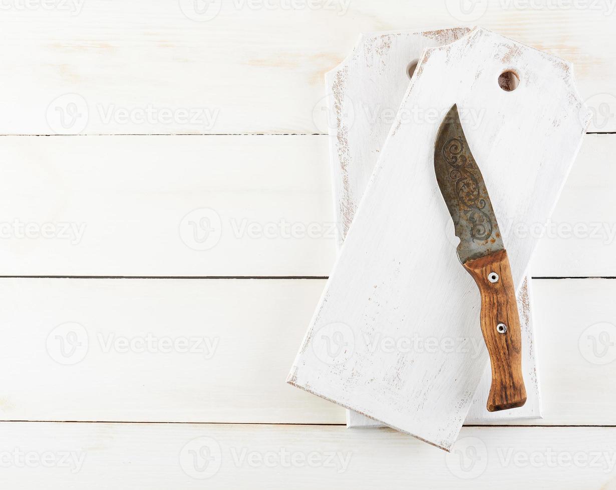 empty wooden cutting board and old knife on the white background photo