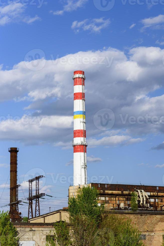 white pipe factory against a blue sky photo