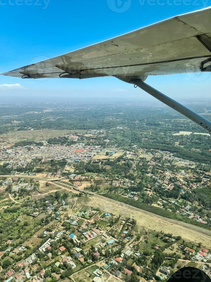 View from an aircraft onto the wing and the savannah in Kenya below. photo