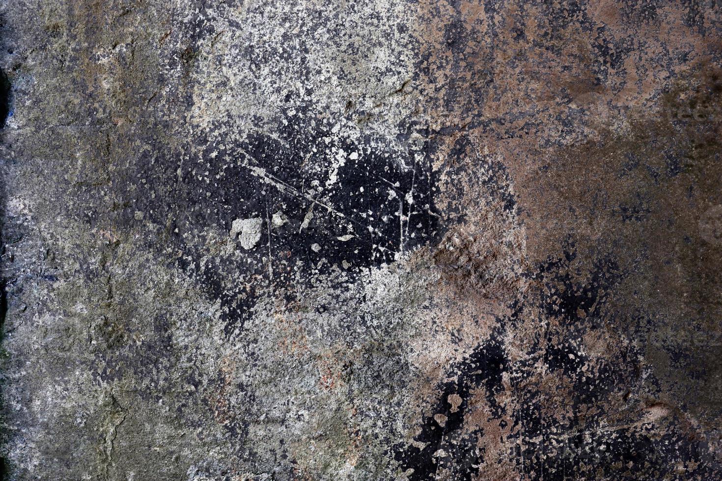 Close up view at a granite and stone wall texture in a high resolution. photo