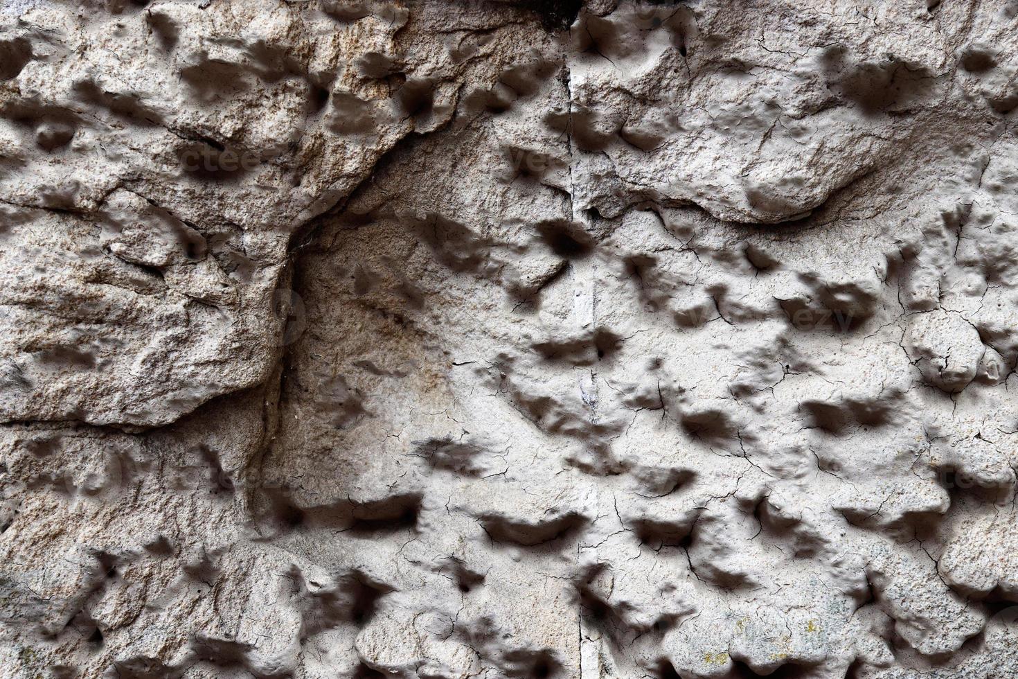 Close up view at a granite and stone wall texture in a high resolution. photo
