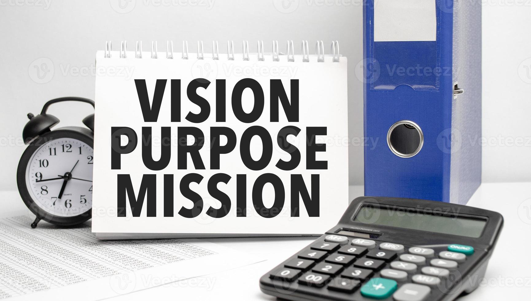 vision purpose mission words on white notebook and calculator, black