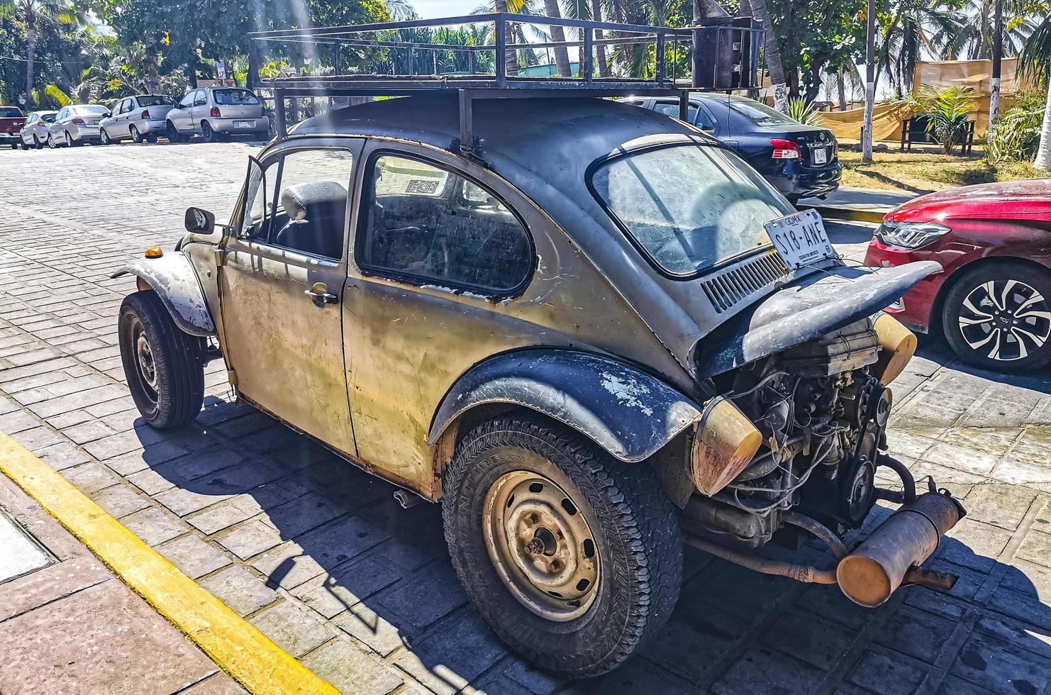 Puerto Escondido Oaxaca Mexico 2022 Old broken rusty and damaged classic vintage cars in Mexico. photo