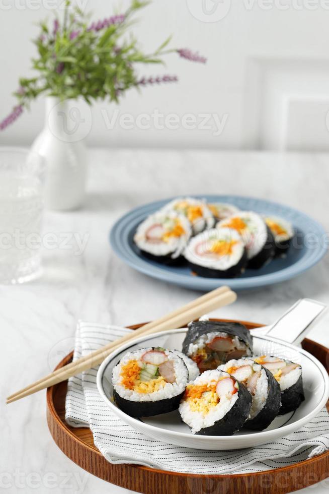 Gimbap or Kimbap Korean Roll Rice with Eggs, Carrot, Sausage, and Nori photo