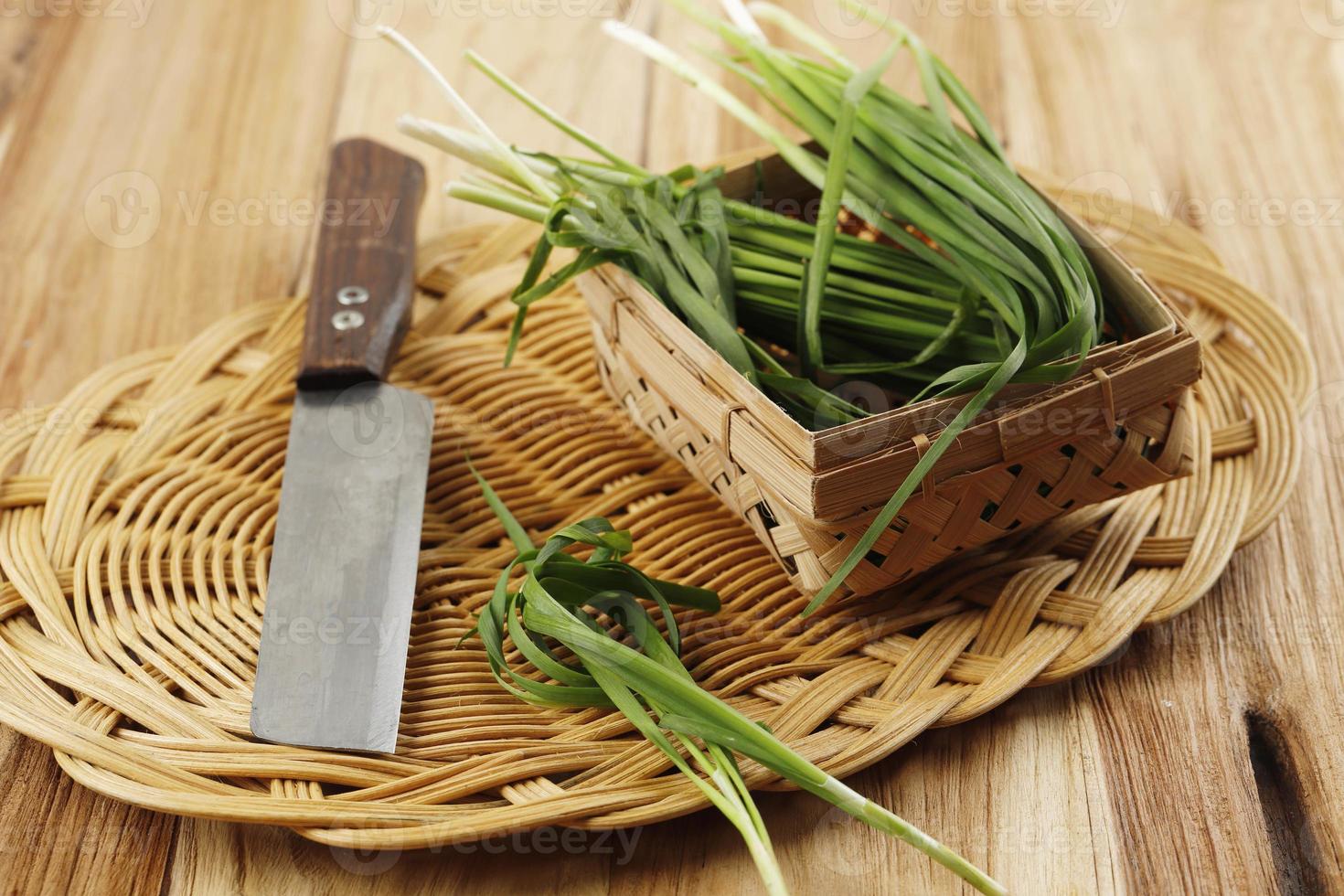 Fresh Chinese Chive or Kui chai Kucai Tie a Rope on Wooden Table. photo