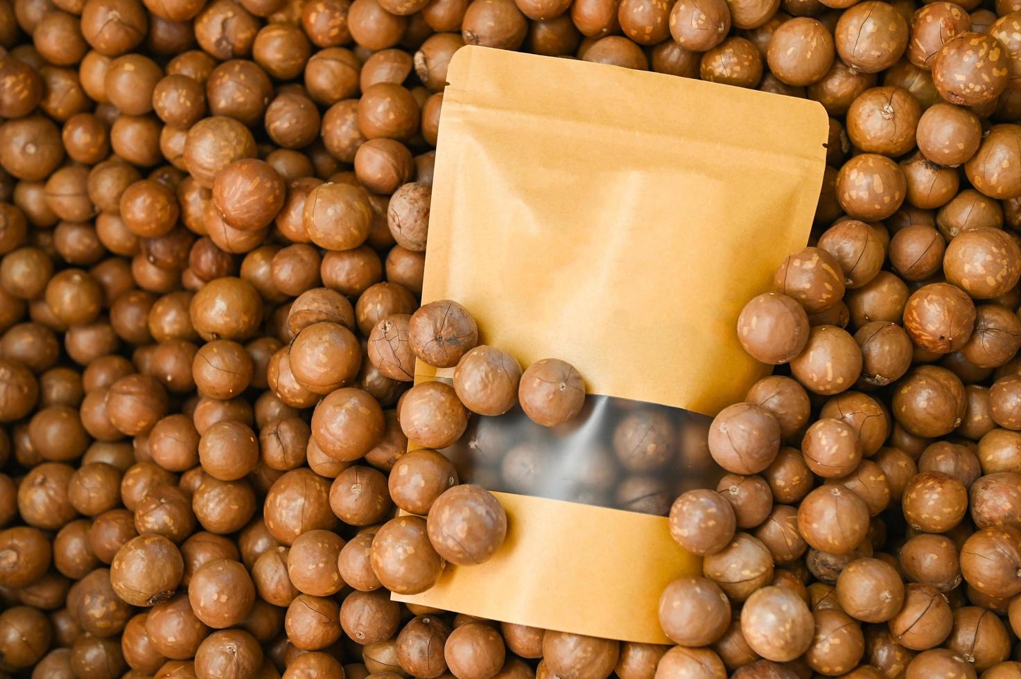 macadamia nuts on basket, fresh natural shelled raw macadamia nuts in a full frame, close up pile of roasted macadamia nut in bag package product photo