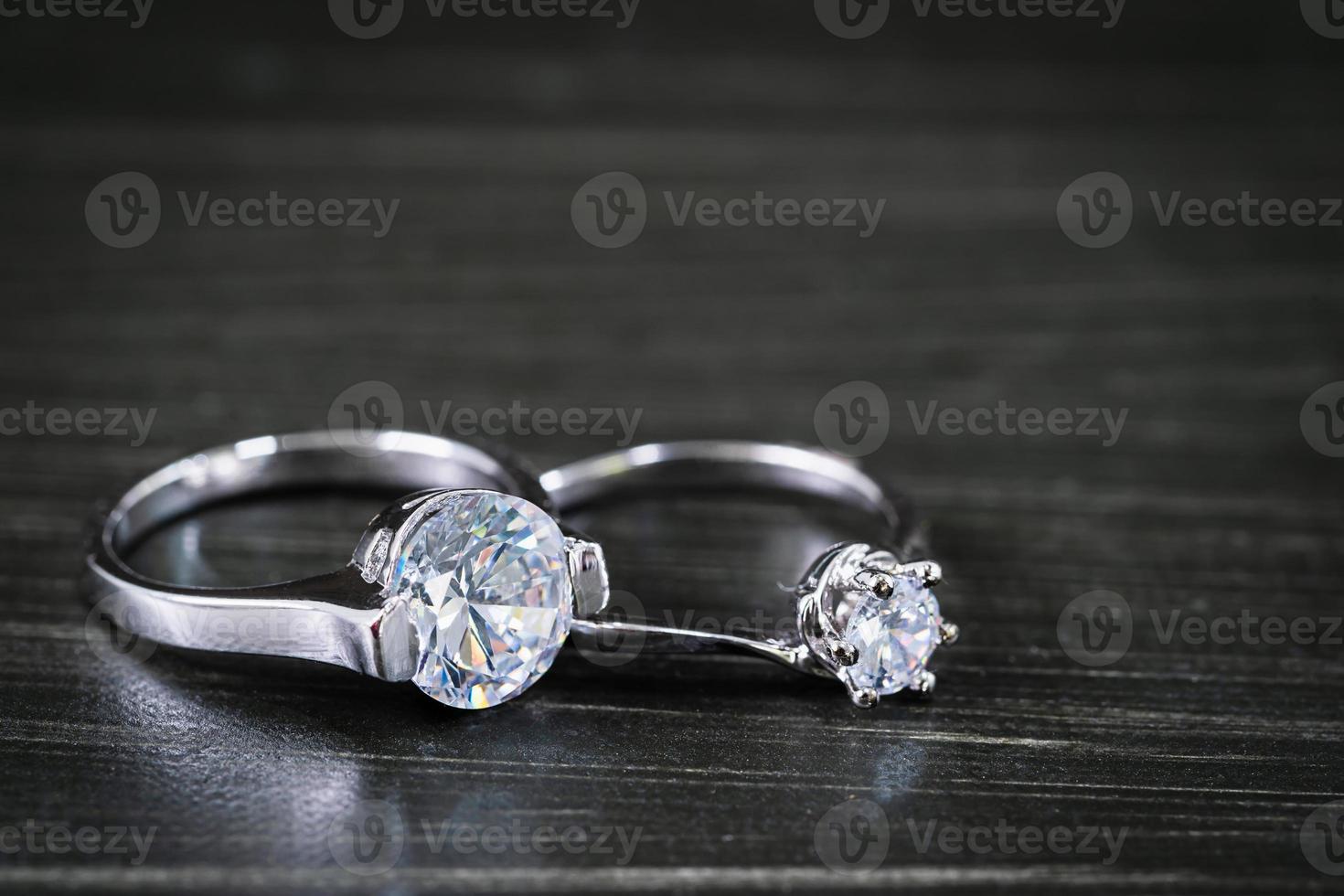 Diamond wedding rings on black background photo
