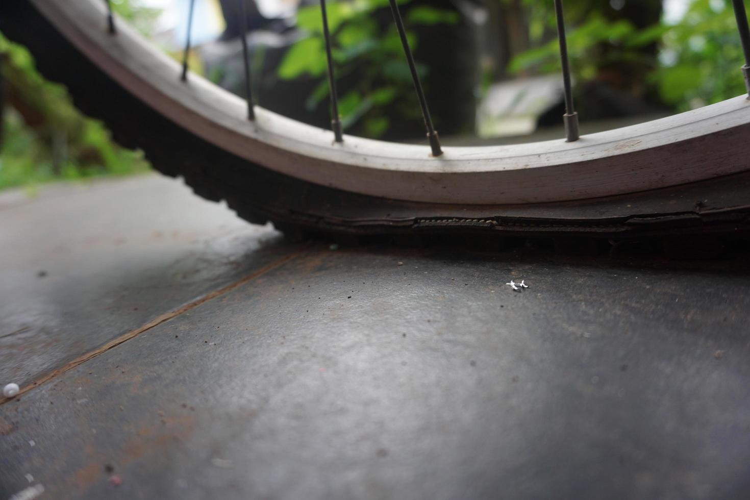 flat bicycle tire in front of the house in the morning photo