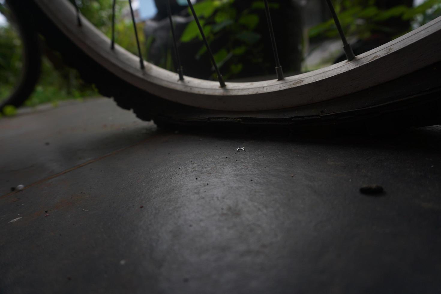 flat bicycle tire in front of the house in the morning photo