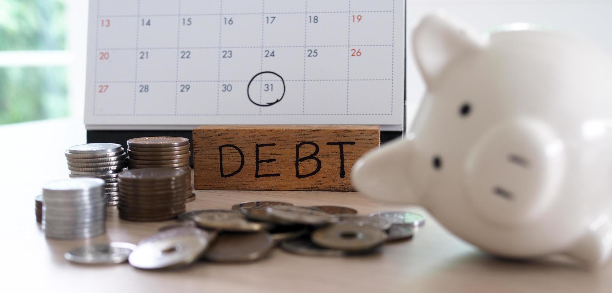 Due for repayment There are coins, calculators and calendar reminders placed on the table. photo