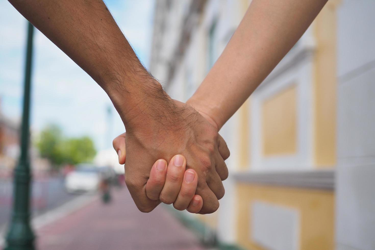 Young man holding a girl Show love and concern. The couple walked together. photo