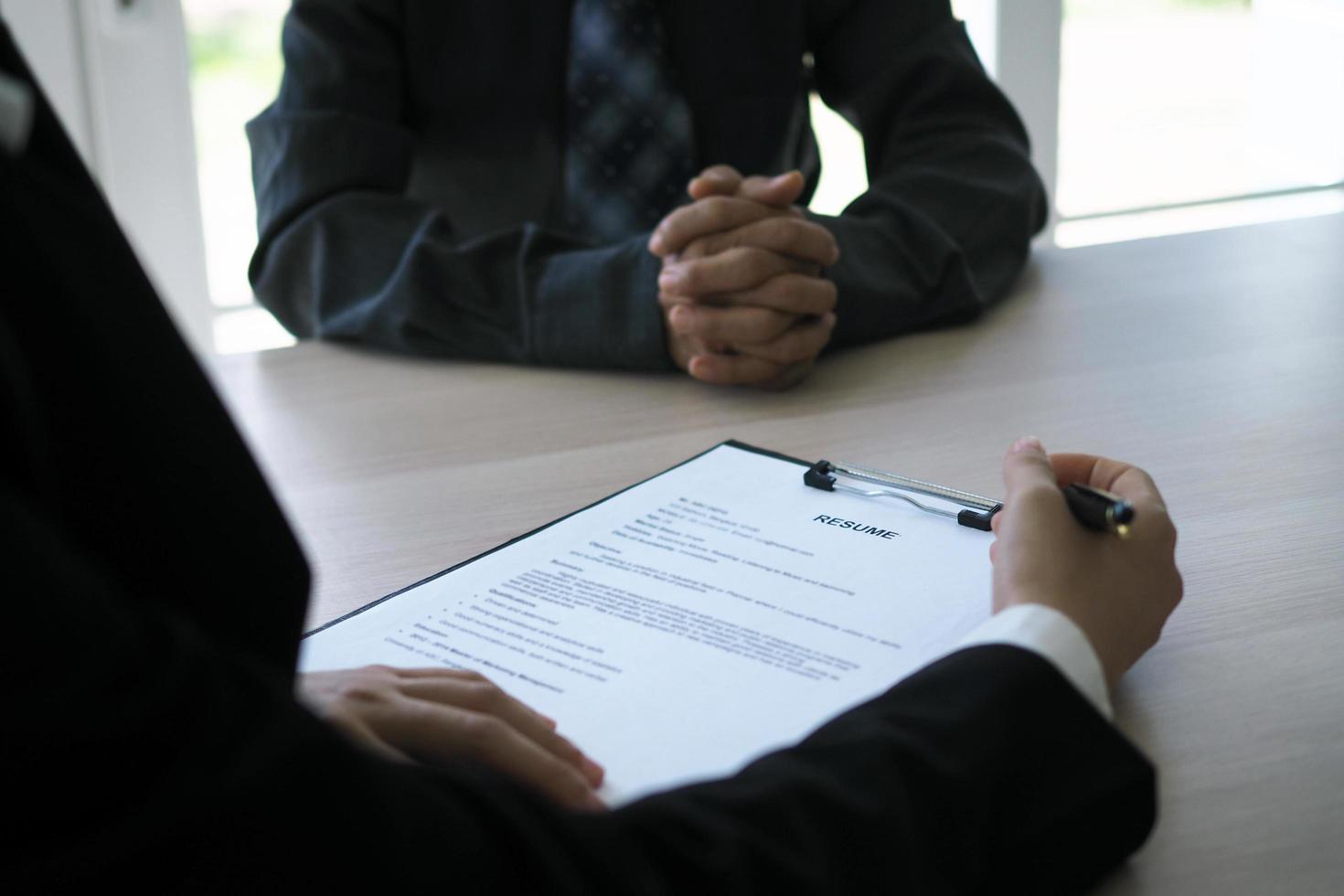 Executives are interviewing candidates. Focusing on resume writing tips, applicant qualifications, interview skills and pre-interview preparation. Considerations for new employees photo