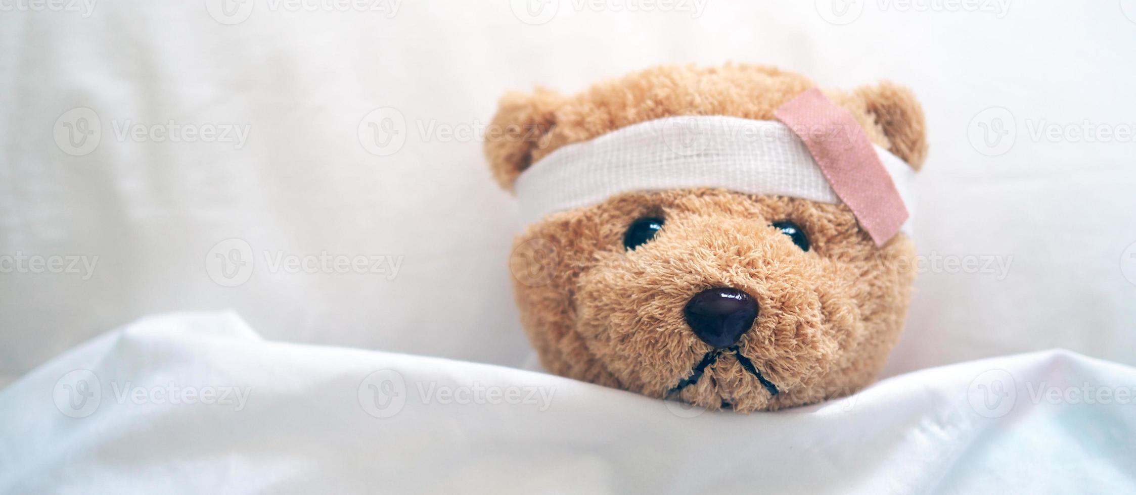 Teddy bear and bandage. Injury concept photo