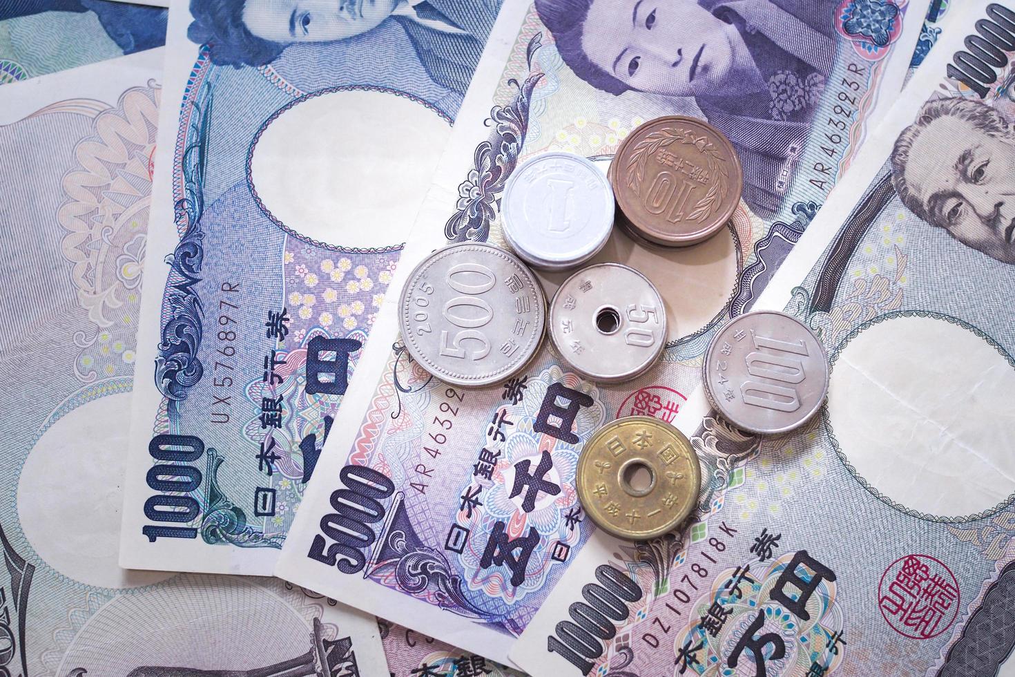 Japanese yen notes and Japanese yen coins for money concept background photo