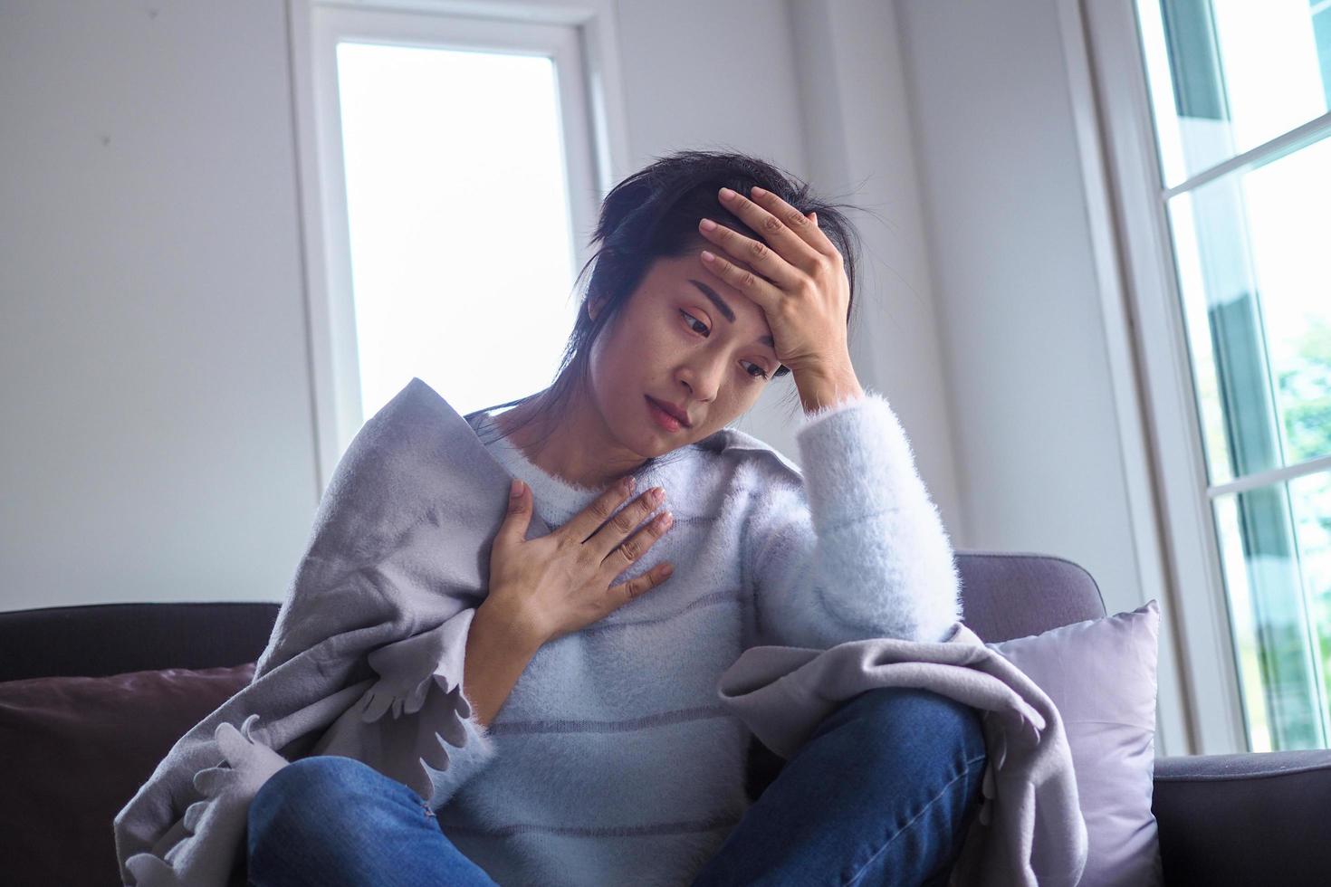 The woman had a headache and chest tightness while sitting at the sofa inside the house. photo