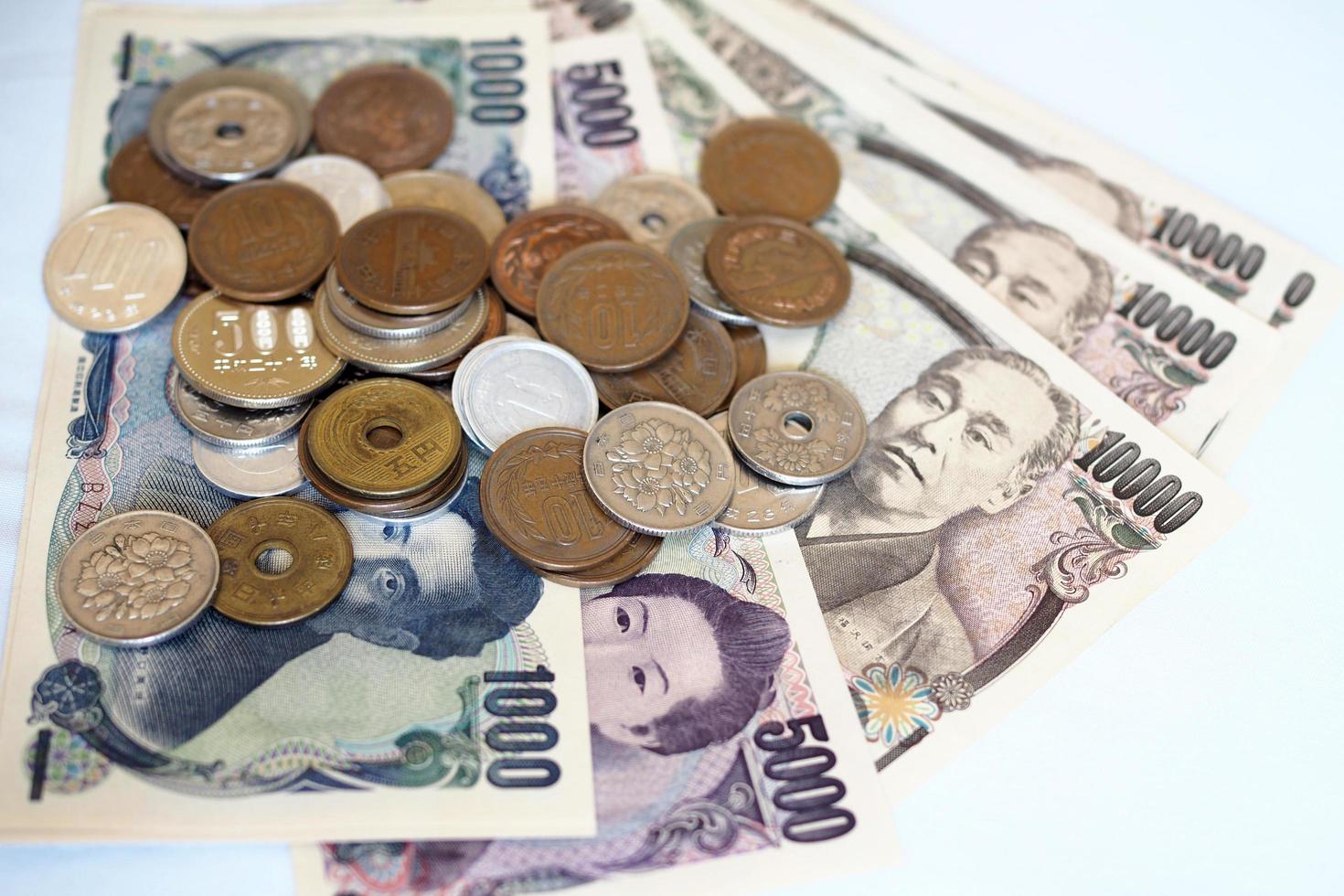 Japanese yen notes and Japanese yen coins for money concept background photo