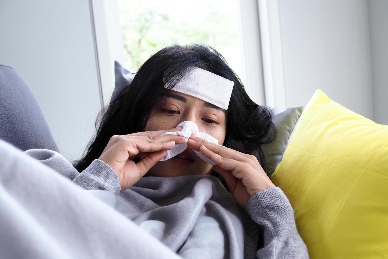 Asian women have high fever and runny nose. sick people concept photo