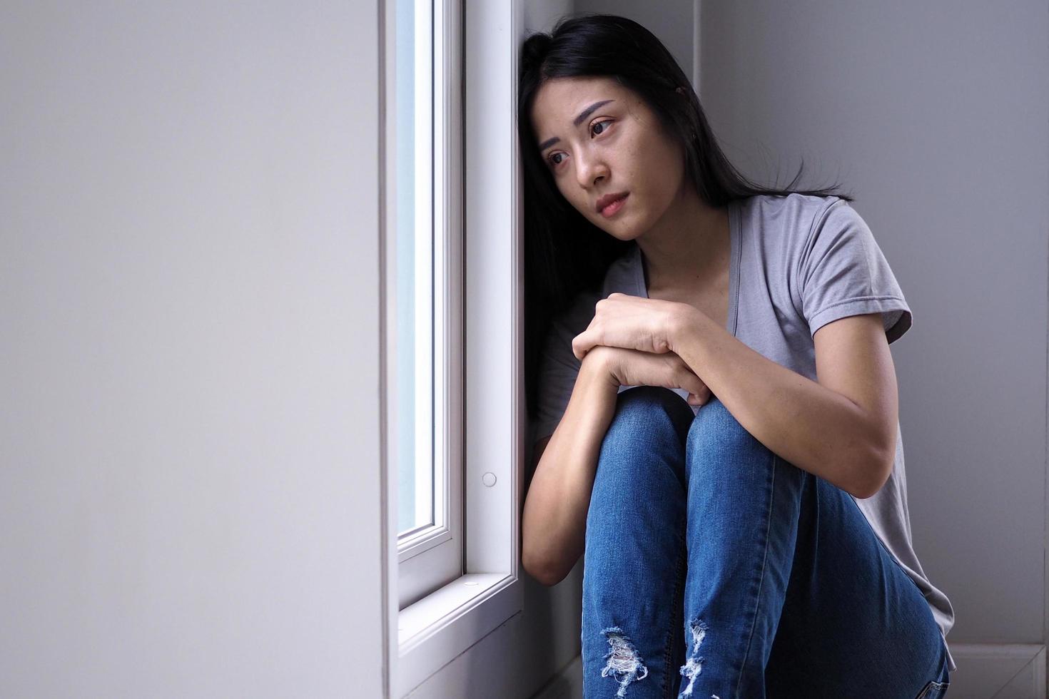 Asian girl sitting alone in the house. Depression concept photo