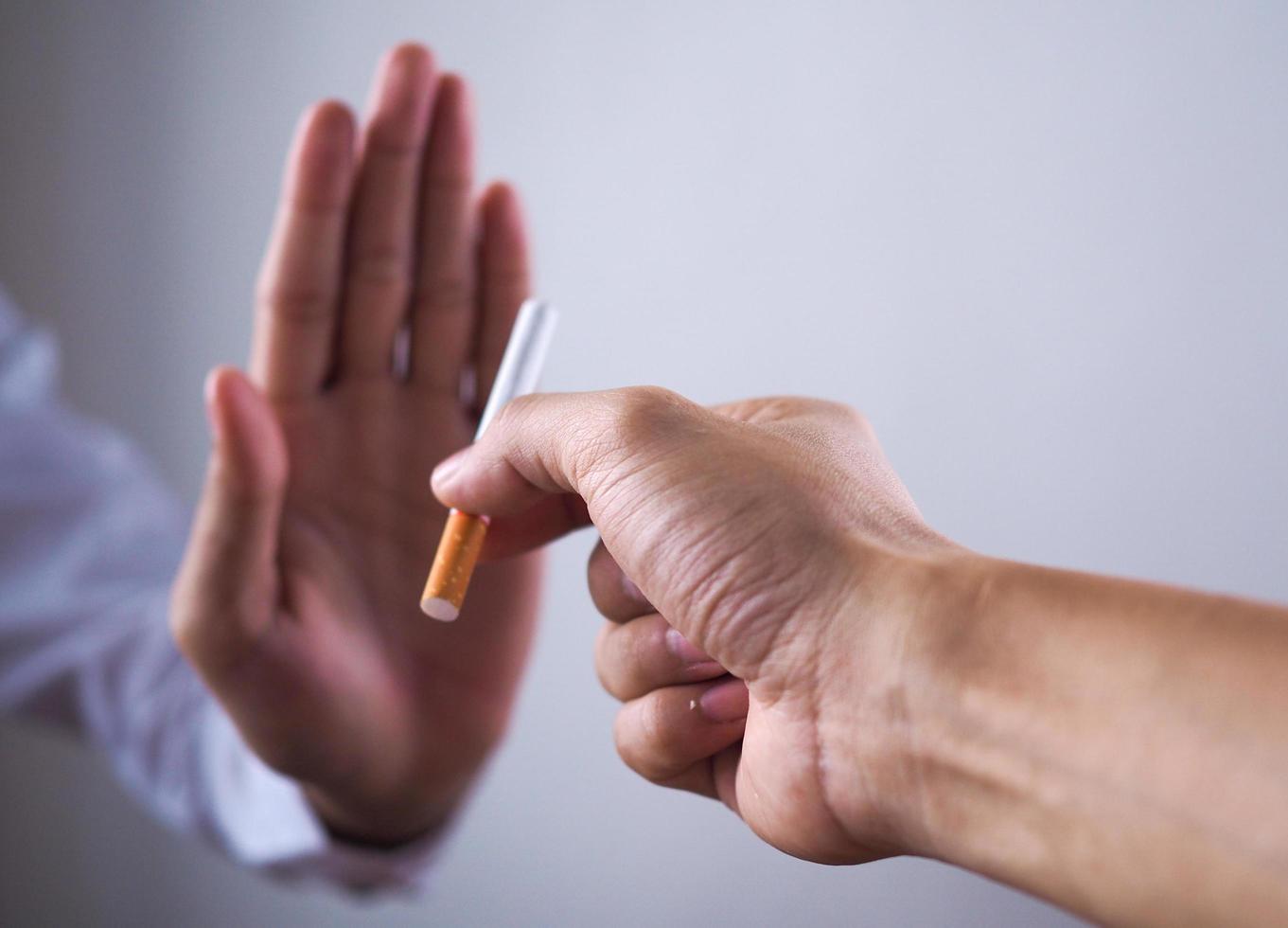 The hand rejected the cigarette that was handed over. Smoking Concepts Causes of Lung Cancer. Just say no photo