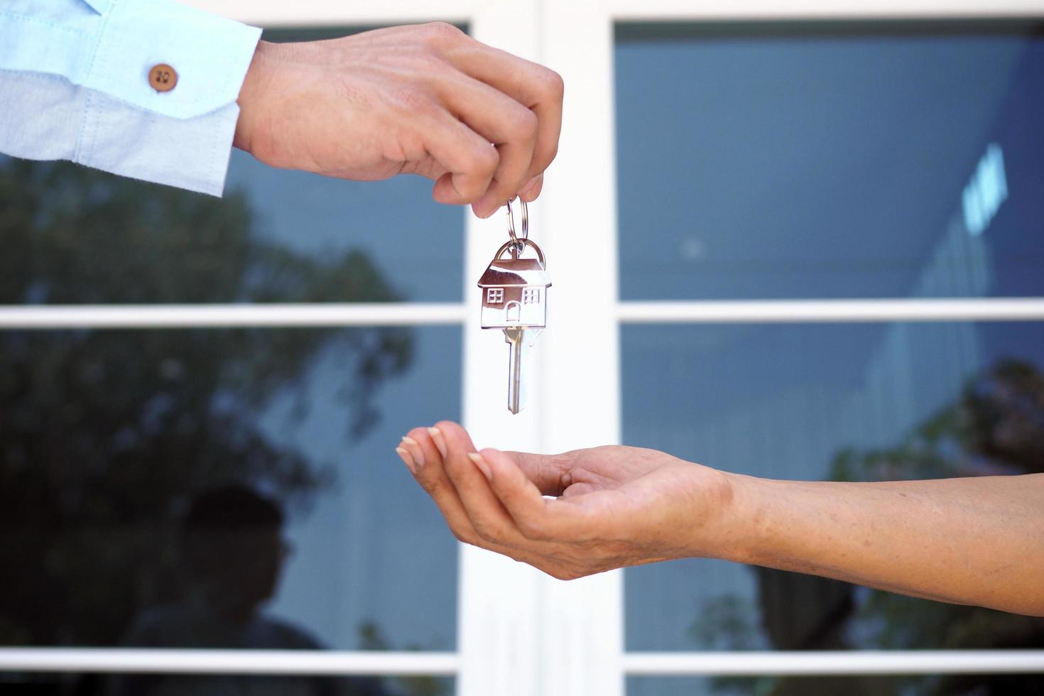 Home buyers are taking home keys from sellers. Sell your house, rent house and buy ideas. photo