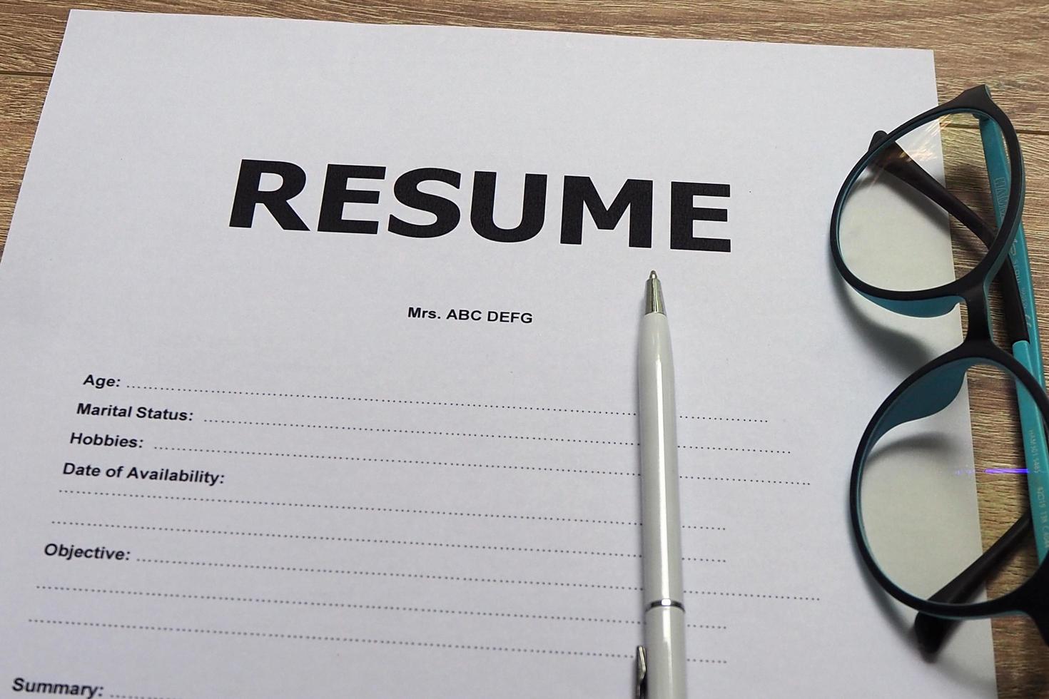 Job Application Form Have pens and glasses. Closeup of Resume. photo