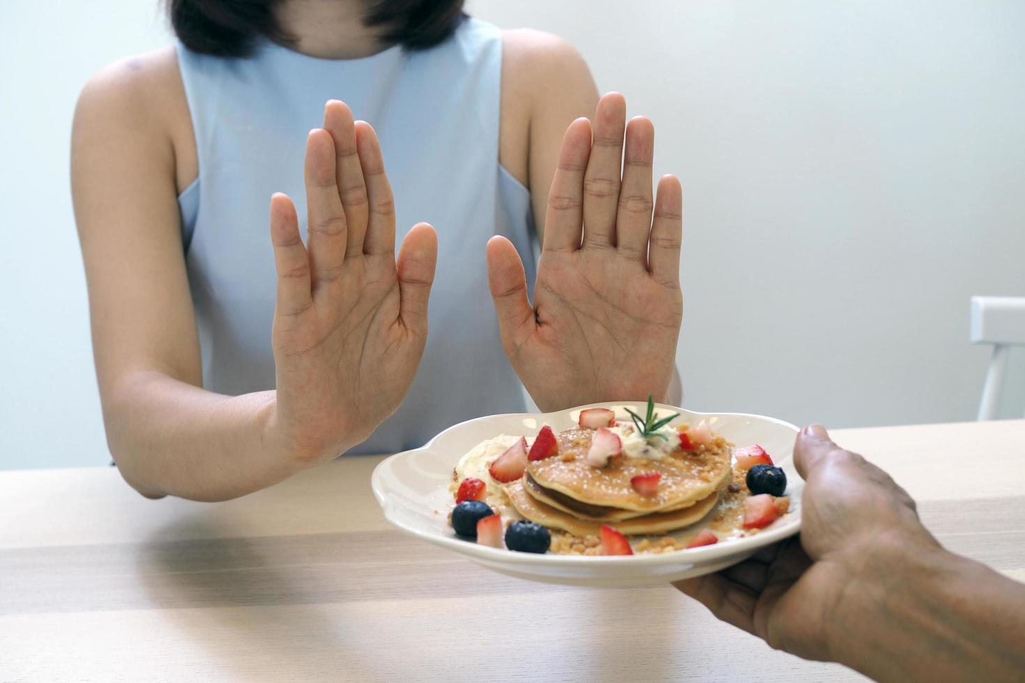 The women used to push the dessert plate with the people.  Do not eat desserts for weight loss. photo