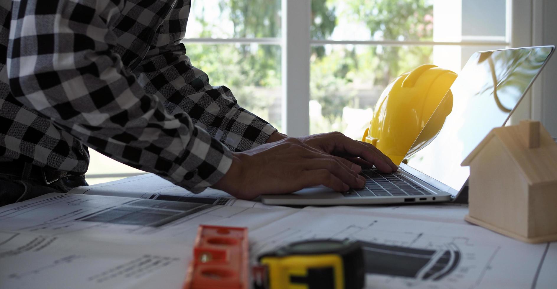 Engineers use laptops and check the blueprint. Prepare construction project planning photo