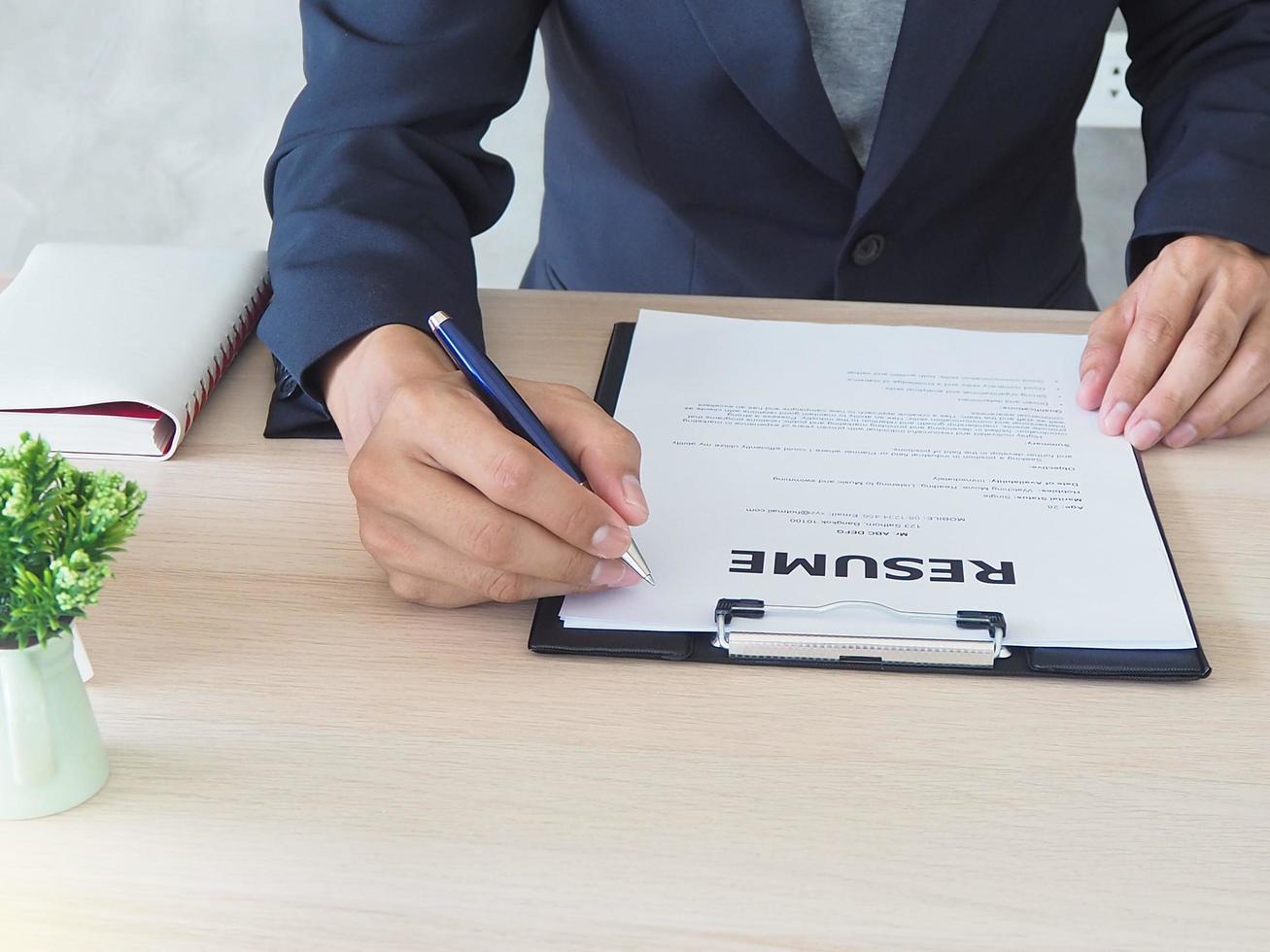 Managers are checking out the cover letter. By sitting on his desk. Resume concept photo