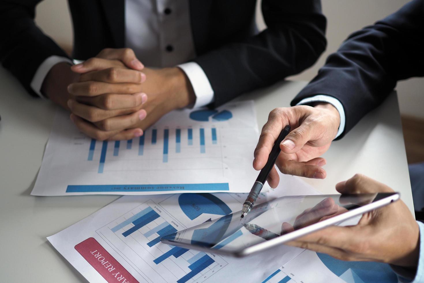 Business people use the tablet to learn and find information for work. View online information photo