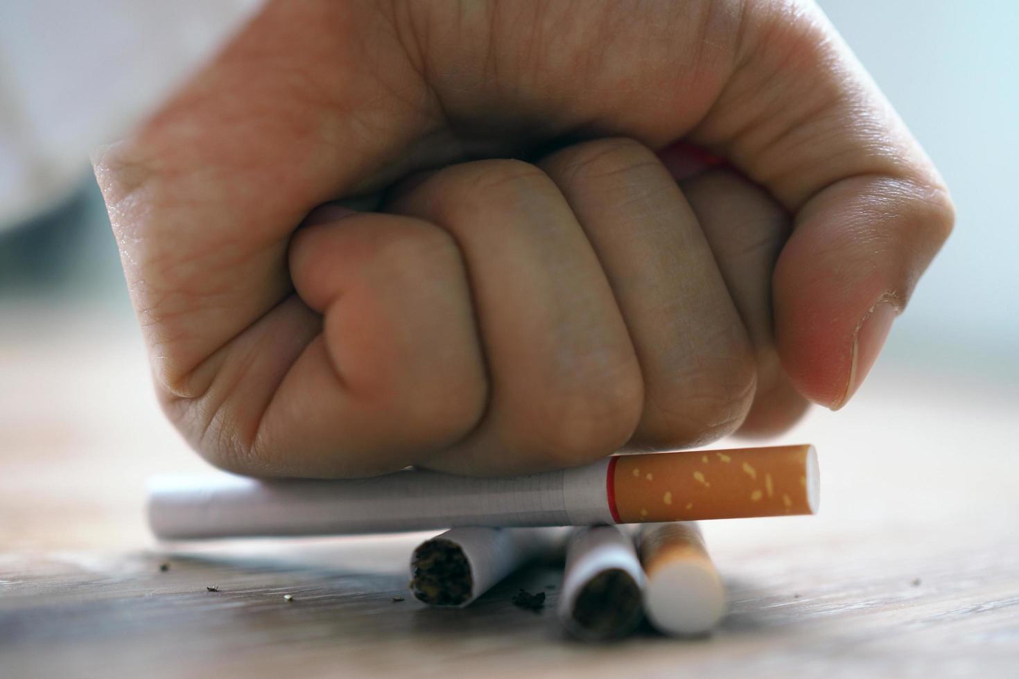 Hand smashed cigarettes The concept of smoking causes lung cancer. Just say no photo