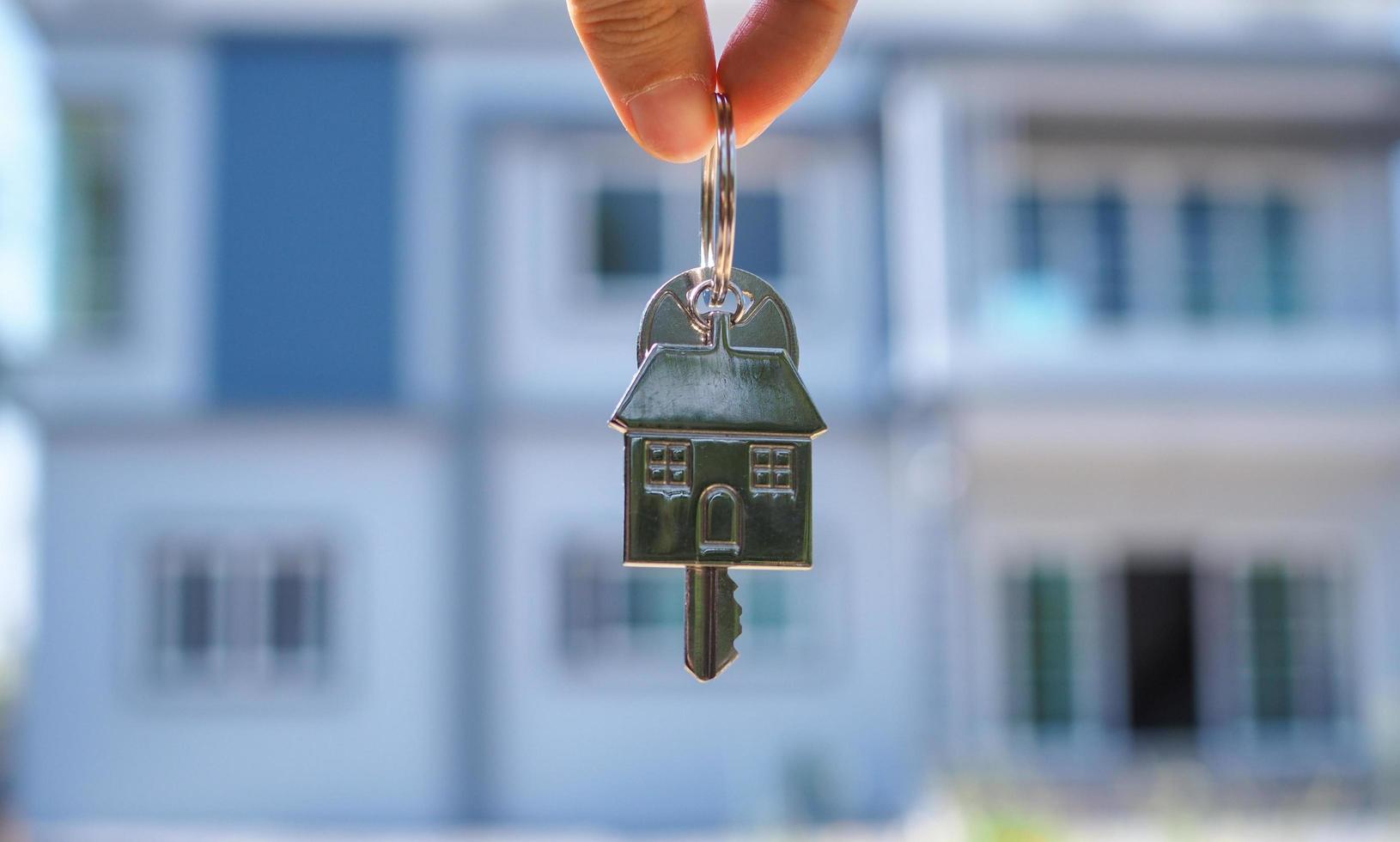 Landlord unlocks the house key for new home photo