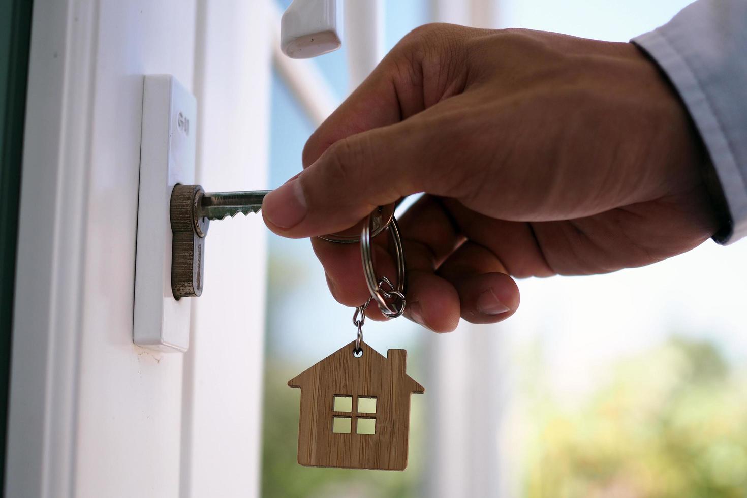 Landlord unlocks the house key for new home photo