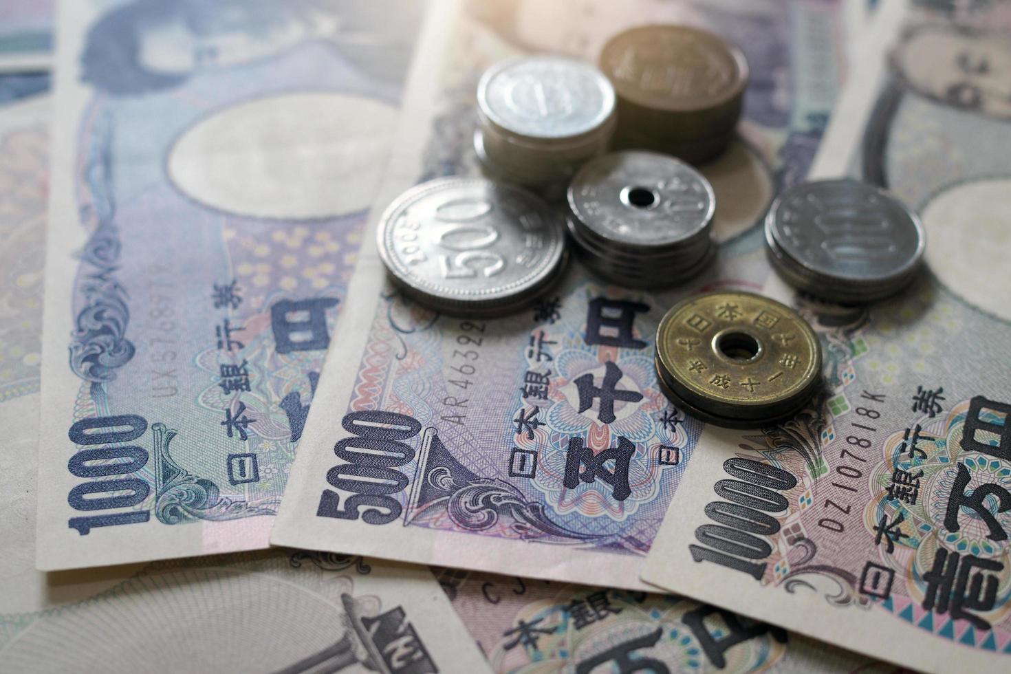 Japanese yen notes and Japanese yen coins for money concept background. photo