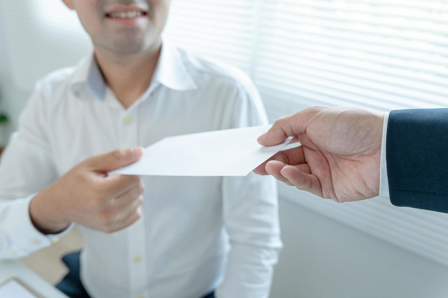 Businessmen receive salary or bonuses from management or Boss. Company give rewards to encourage work. Smiling businessman enjoying a reward at the desk in the office. photo