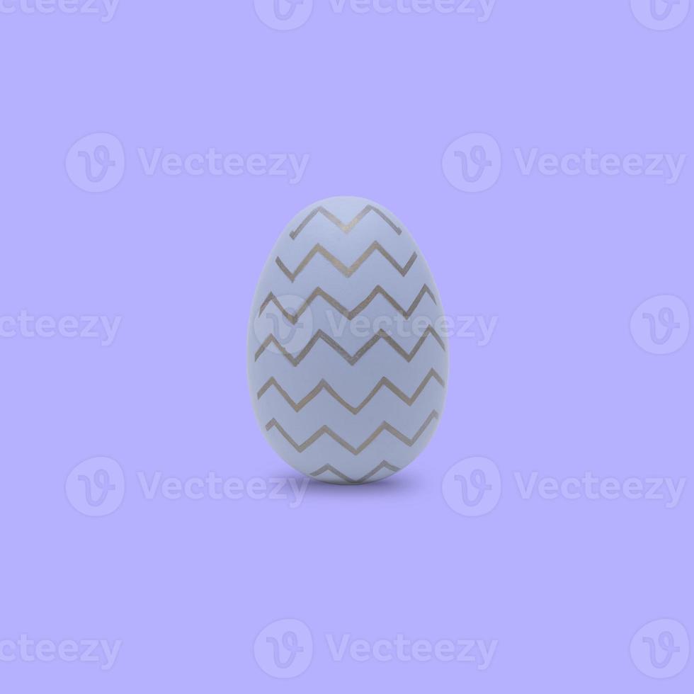 Happy Easter. Beautiful purple egg with different pattern on purple background. photo