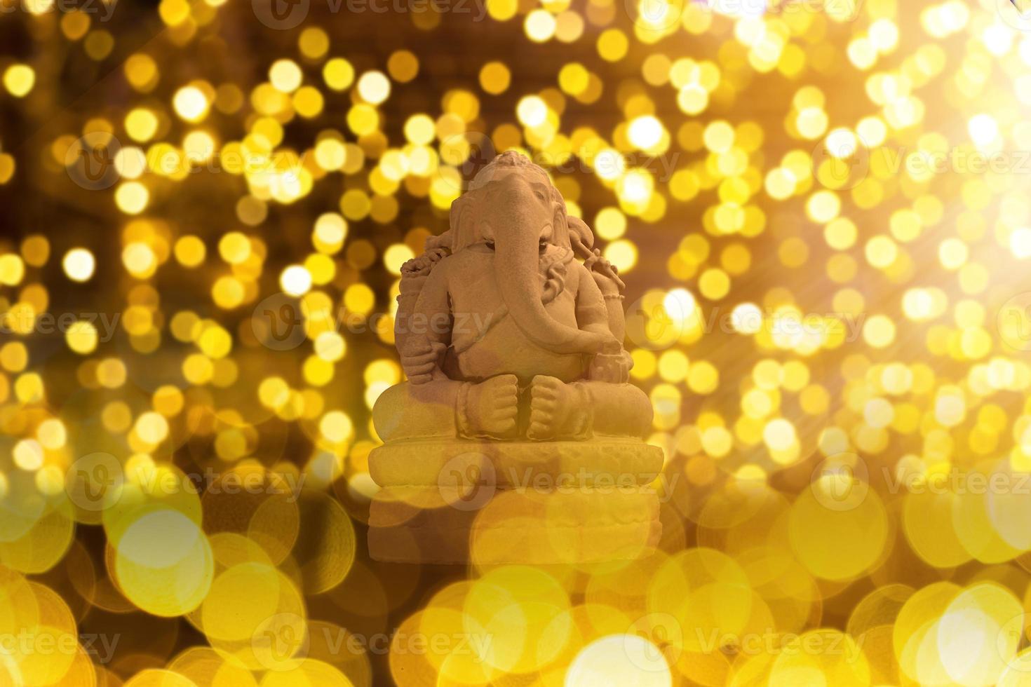 Selective focus on statue of Lord Ganesha, Ganesha Festival. Hindu religion and Indian celebration of Diwali festival concept on dark, red, yellow background. photo