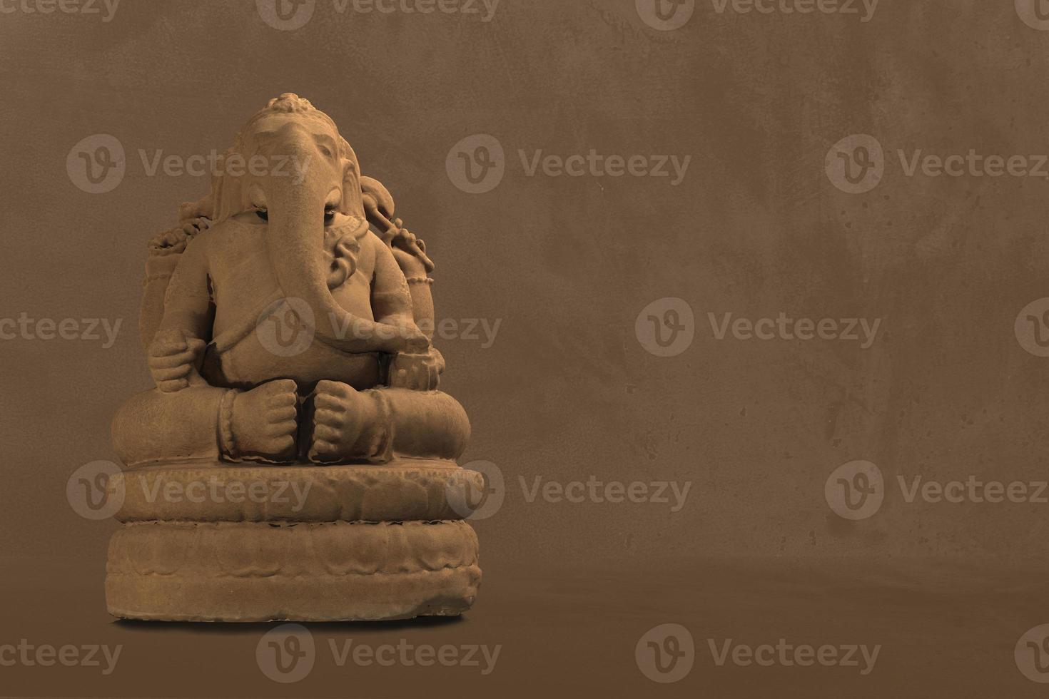 Selective focus on statue of Lord Ganesha, Ganesha Festival. Hindu religion and Indian celebration of Diwali festival concept on dark, red, yellow background. photo