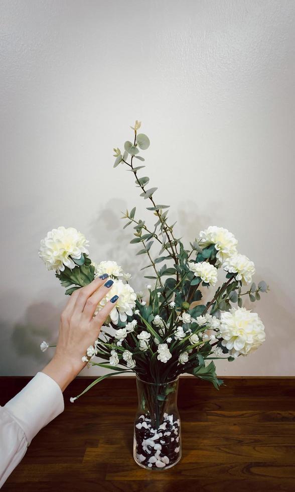 Beautiful hands of woman with dark manicure on nails with flower. photo