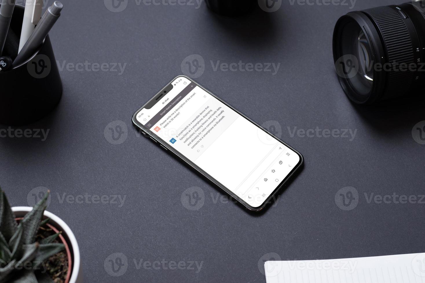 Phone on work desk with AI chat app. Chatbot auto-generative system use concept photo