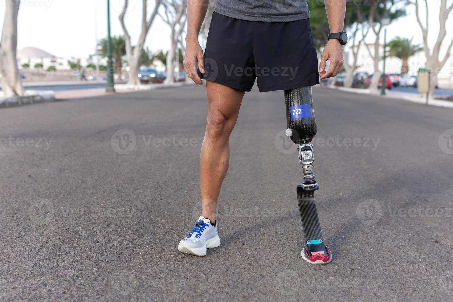 Crop runner with blade leg prosthesis during training in city photo