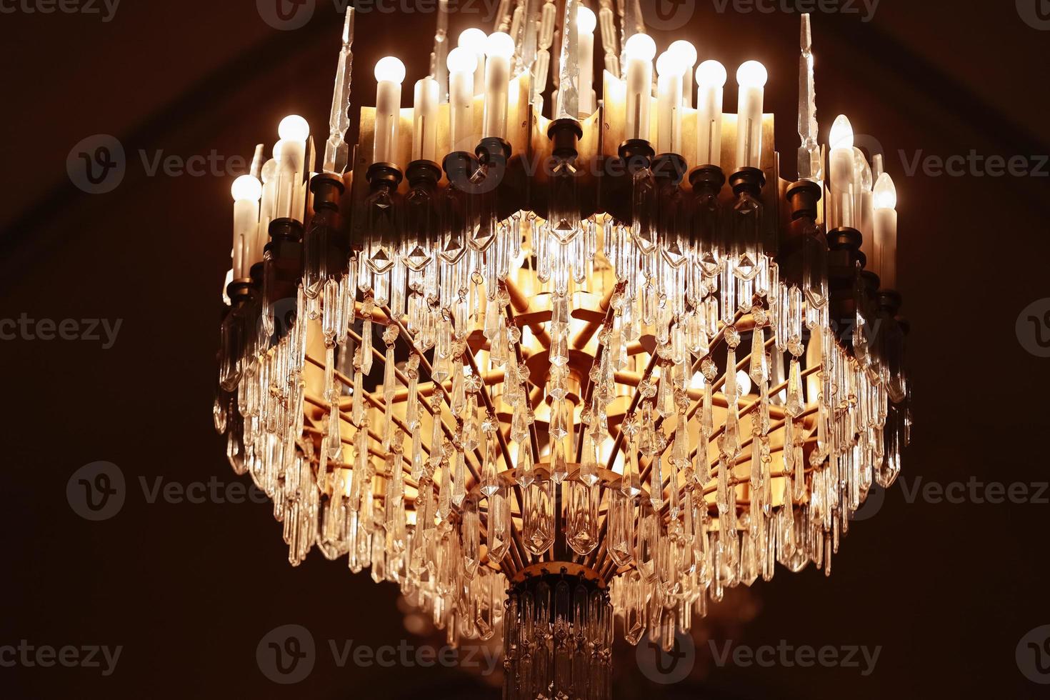 Elegant luxury crystal chandelier on ceiling, beautiful chandelier. Emphasis on luxury, used in various places such as palace church, residence..Decorative elegant vintage and Contemporary Concept. photo