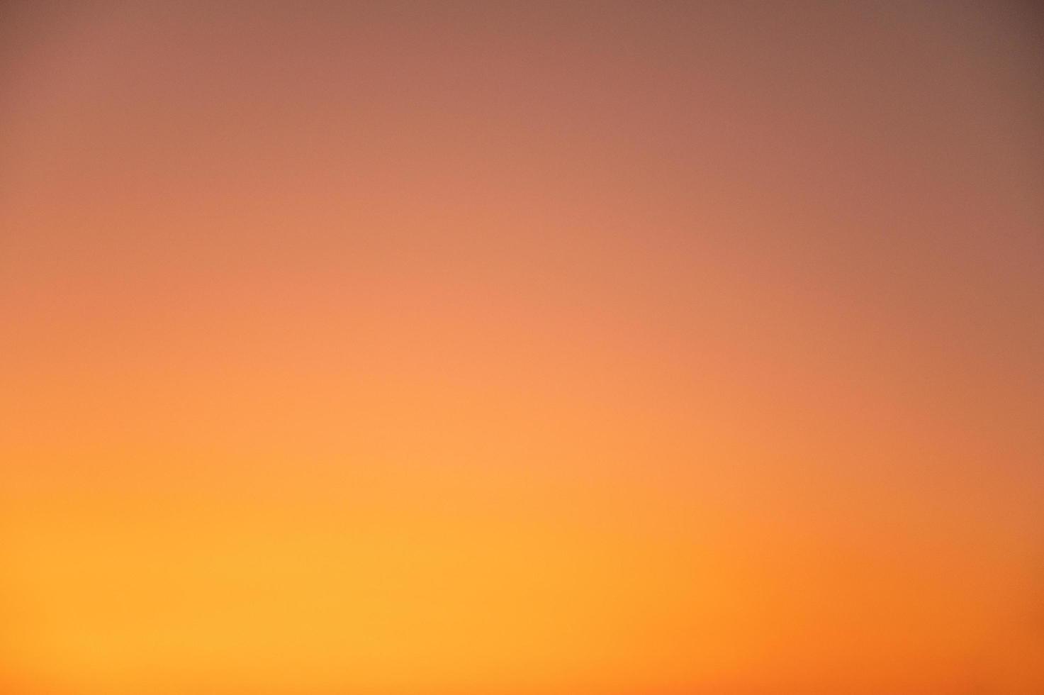 De-focus of beautiful clear orange sky during sunset. photo