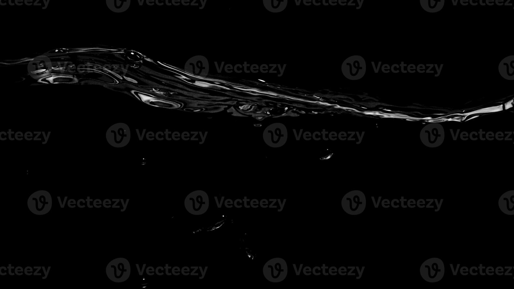 Liquid suface line between underwater and above water with black background. photo
