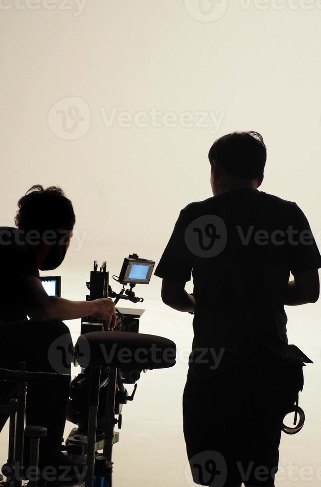 Behind the scenes of silhouette working people that making movie. photo