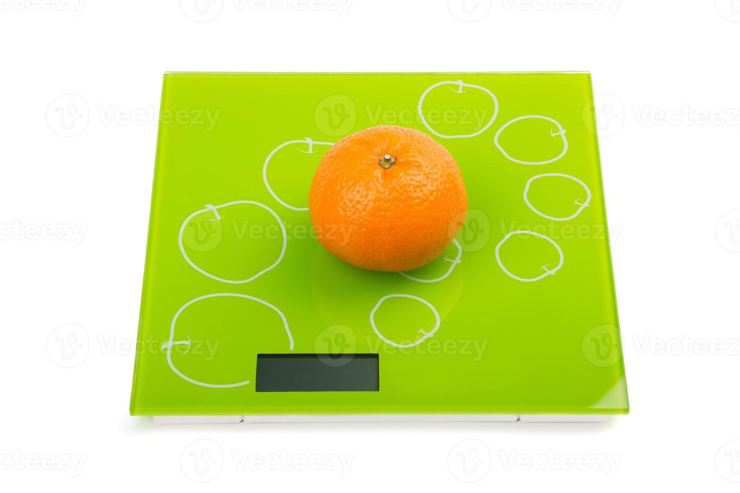 Sweet mandarin on scales photo