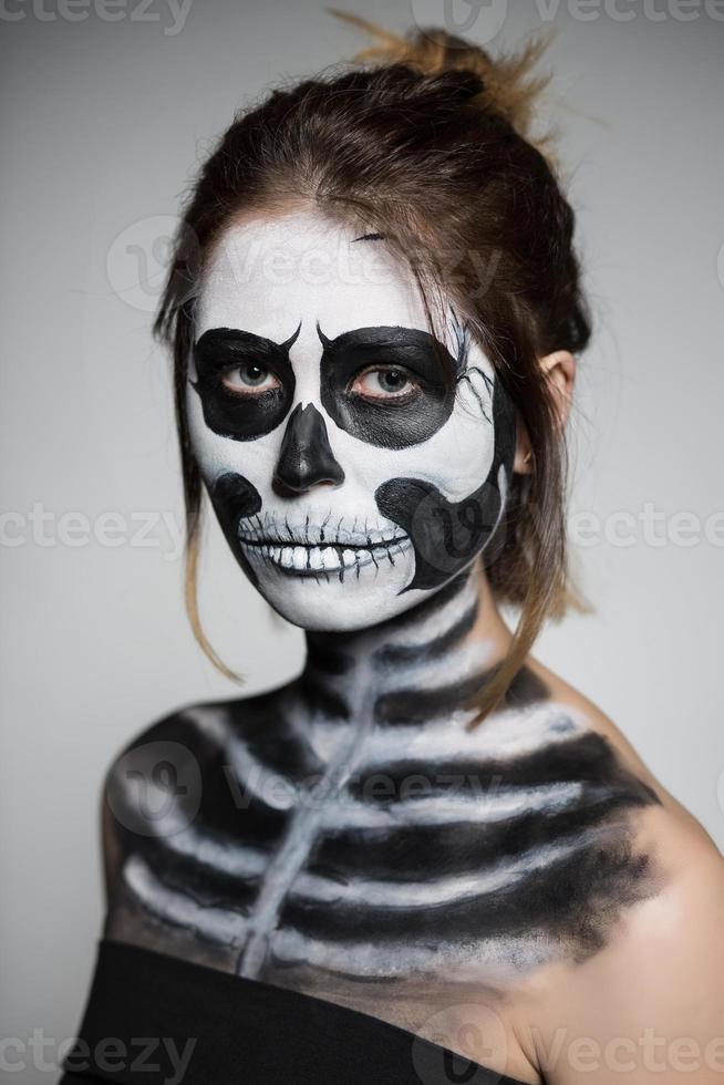 Woman painted like a zombie photo