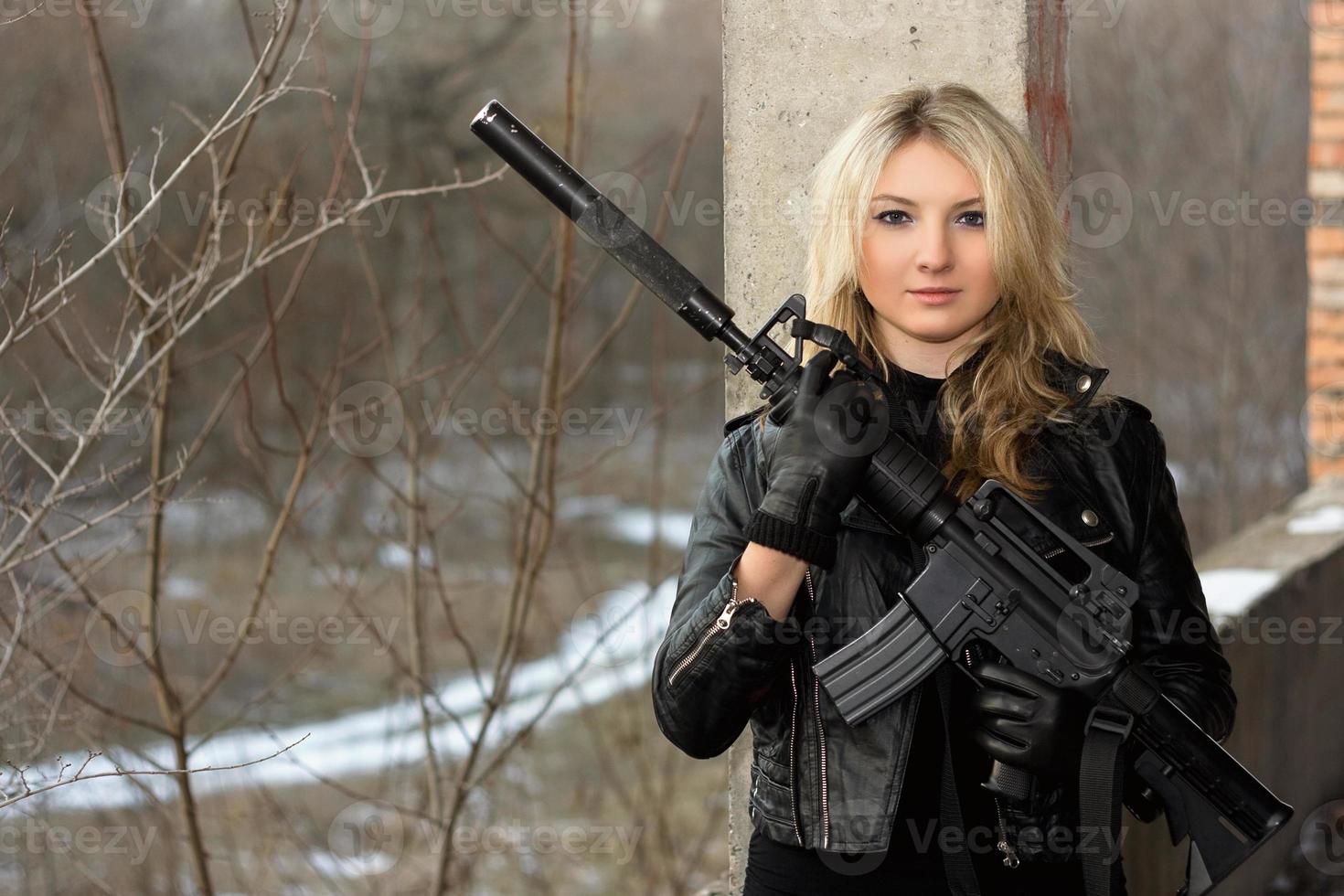 Scared girl with a rifle photo