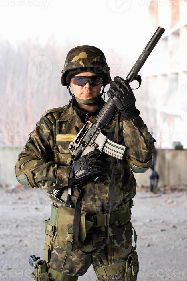 Handsome guy holding a rifle photo