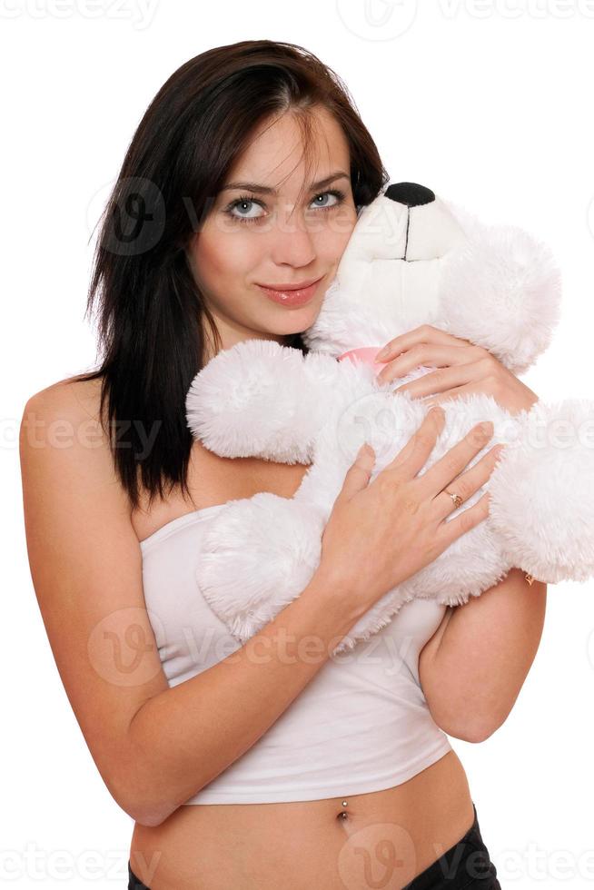 linda chica soñadora con un oso de peluche foto